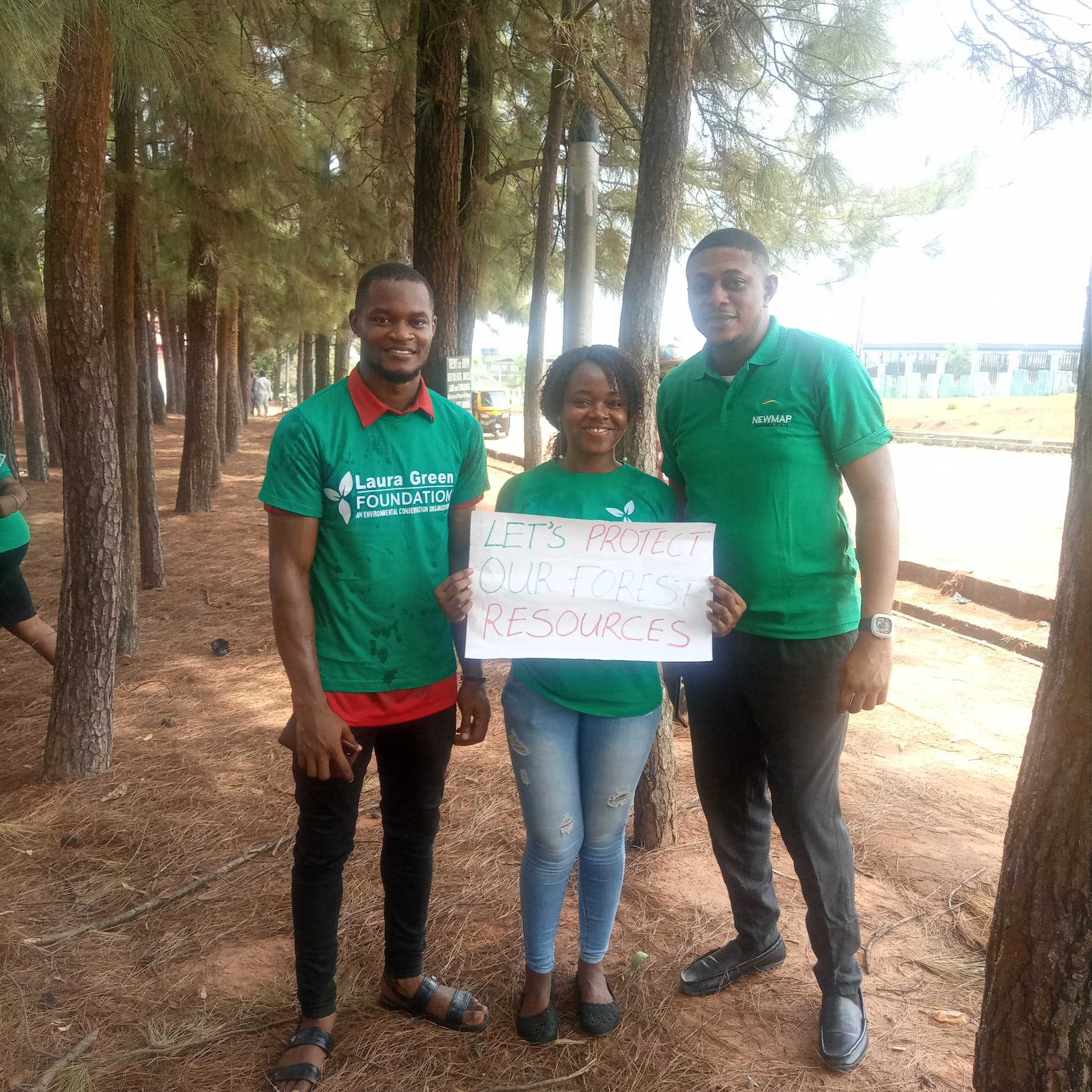 Mrs Mmachukwu Obimdike and fellow environmental enthusiast. Mrs Mmachukwu is holding a plaque that says Let us protect our forest resources